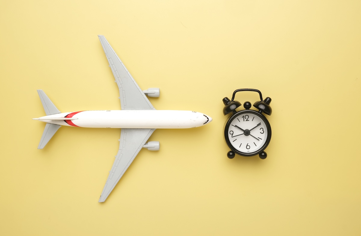 airplane-and-clock-on-a-yellow-background-2026-03-16-04-37-19-utc