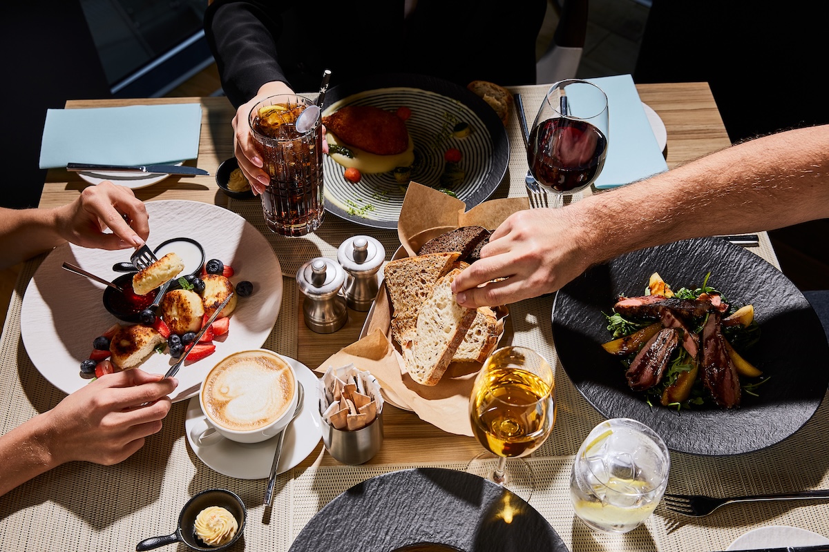 cropped-view-of-people-eating-delicious-food-in-re-2026-03-12-22-45-51-utc