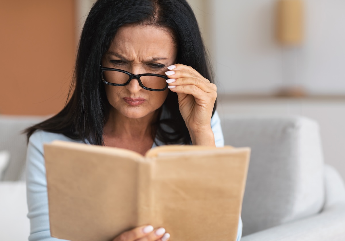 senior-confused-woman-in-glasses-trying-to-read-bo-2025-03-18-18-32-27-utc